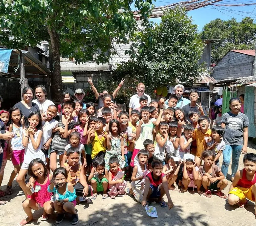 Children and families gathered in a Philippine village served by a new water treatment system